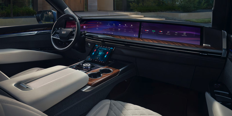Luxury 2025 Cadillac Escalade interior featuring a wide dashboard with digital screens and a modern console.
