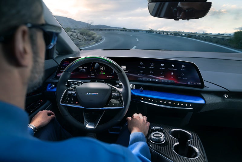 Front View of the 2026 OPTIQ-V Driving Through the Dusk Utilizing its Headlights | Grubbs Cadillac of Wichita Falls in WICHITA FALLS TX